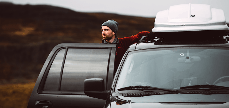 roof box installs on top of a black car.