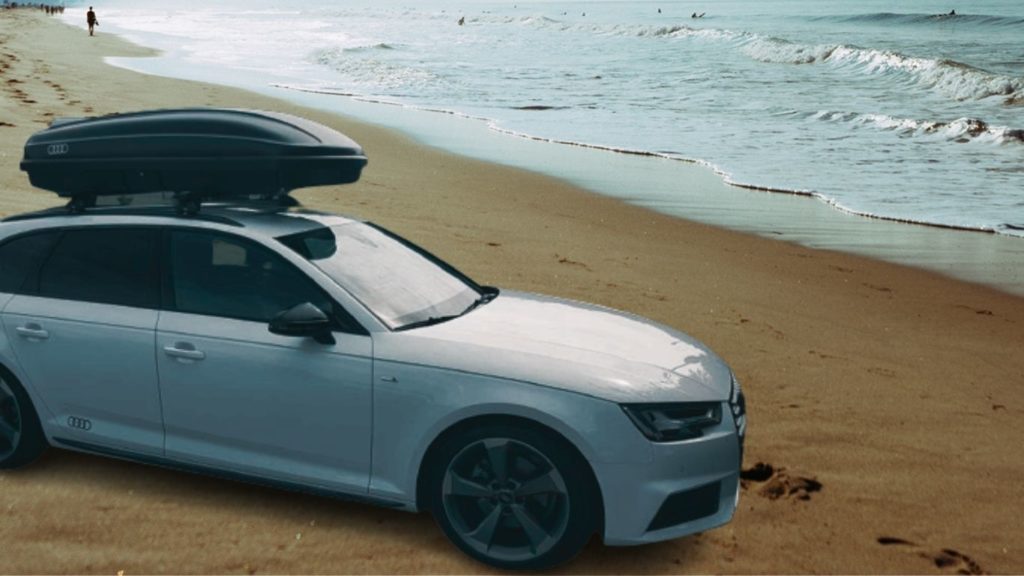 We park our Audi A4 on the beach with an OEM cargo box on top of it and wait for the sunset.