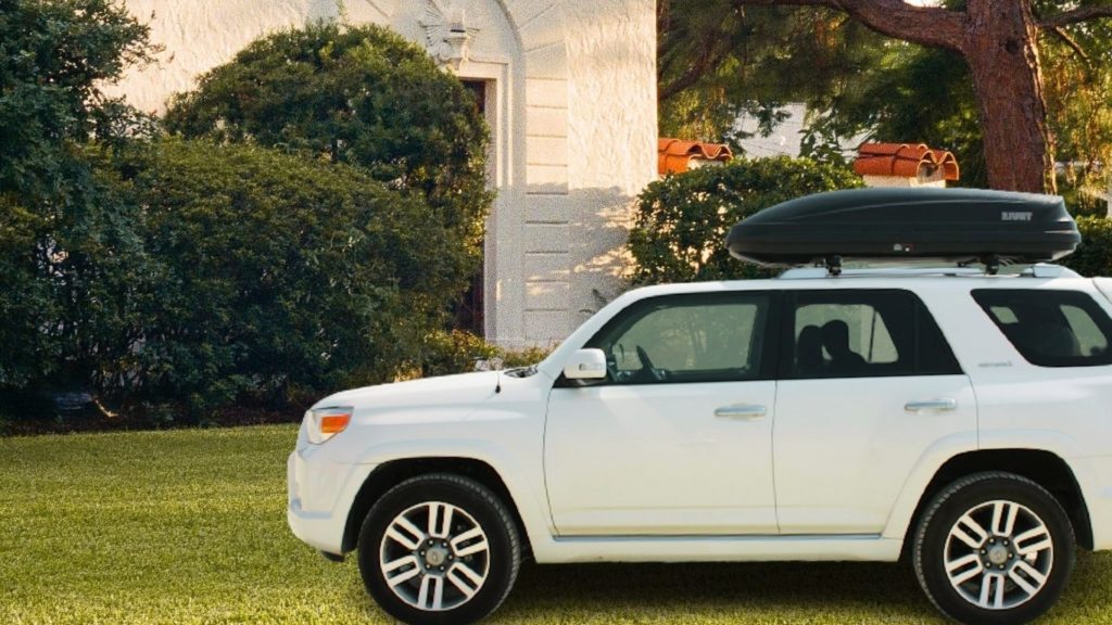 Thule Pulse Medium size car rooftop luggage box on top of my white Toyota 4Runner carrying luggage for me in summer camping time in California