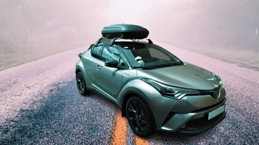 I drive my green Toyota CHR in snow with gray roof box on top for carrying what I need in the woods with my fellow campers.
