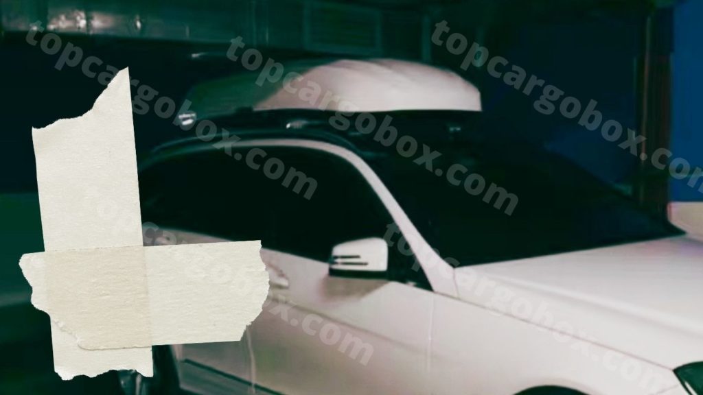 driving car with white INNO roof cargo box in underground parking zone