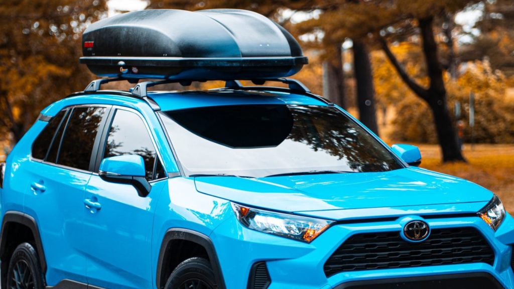 Black Yakima roof cargo box on top of blue Toyota SUV
