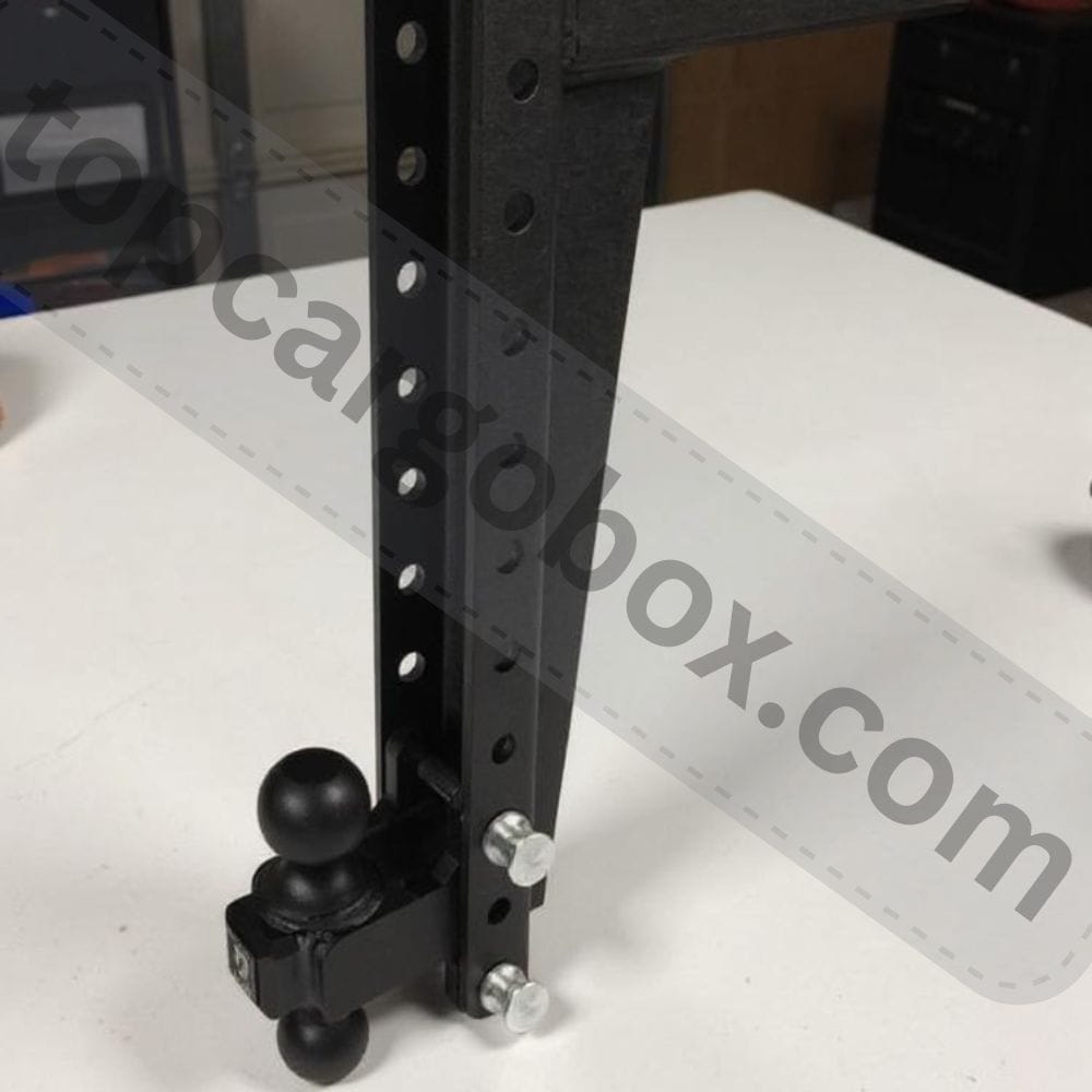 Close-up of a powder-coated steel hitch shank sliding into a truck's receiver tube.
